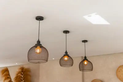 a group of lights hanging from a ceiling at Villa Anna - Havre de paix in Oulad Ikhia