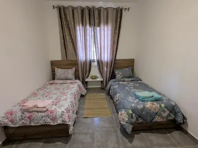 a bedroom with two beds and a window at Dar SAÏDA in Marrakech