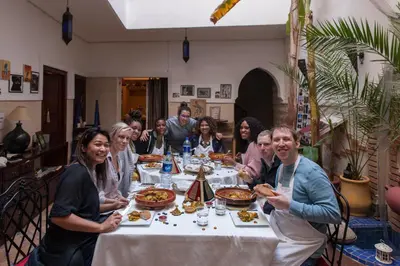 a group of people sitting at a table eating food at Riad Thycas in Marrakech