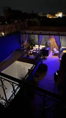 a view of a swimming pool at night at Riad Thycas in Marrakech