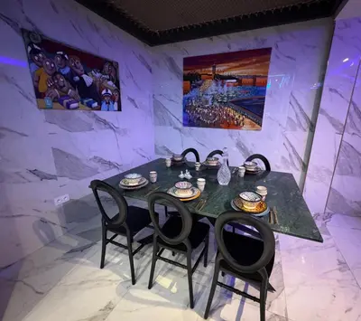 a dining room with a black table and chairs at Beautiful new modern house with full comfort in Marrakech