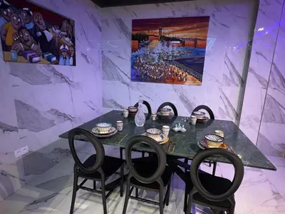 a dining room with a table and four chairs at Beautiful new modern house with full comfort in Marrakech