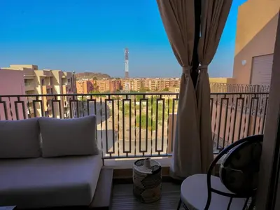 a living room with a couch and a balcony at Suite Sofia Suite avec superbe terrasse Gueliz in Marrakech