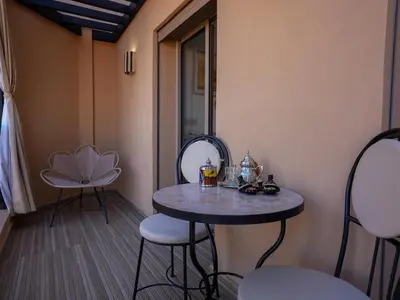 a small table and chairs in a room at Suite Sofia Suite avec superbe terrasse Gueliz in Marrakech