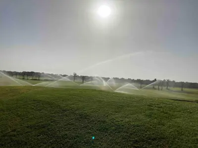 a group of water sprinklers in a field at Beautiful residence with pools inMarrakech Golf City in Marrakech