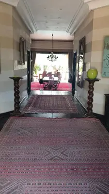 a living room with a large rug on the floor at Dar abie in Sraghna