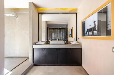 a bathroom with a sink and a large mirror at Luxury 1 BDR Hivernage in Marrakech