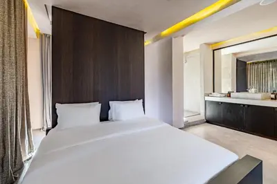 a bedroom with a large white bed and a bathroom at Luxury 1 BDR Hivernage in Marrakech