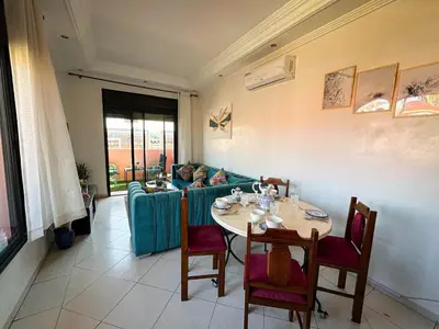 a living room with a table and a couch at Amazing Apartment Center city in Marrakech