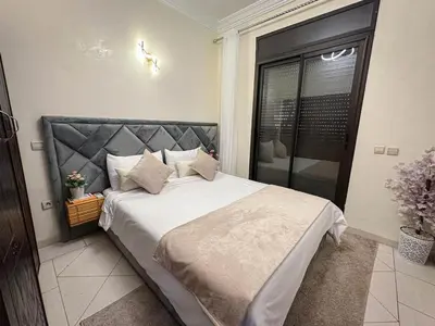 a bedroom with a large bed and a window at Amazing Apartment Center city in Marrakech