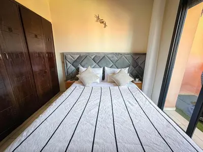 a bedroom with a large bed with a large wooden headboard at Amazing Apartment Center city in Marrakech
