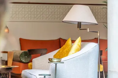 a living room with a couch and a lamp at Riad Habouba in Marrakech