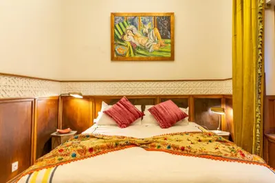 a bedroom with a bed and a painting on the wall at Riad Habouba in Marrakech