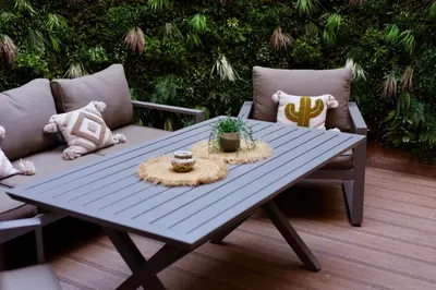 a blue picnic table with two chairs and a couch at Luxueux DUPLEX au cœur Marrakech in Marrakech