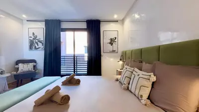 a bedroom with a large bed with pillows at Luxueux DUPLEX au cœur Marrakech in Marrakech