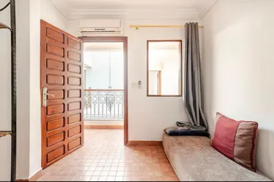 a room with a door and a couch and a window at Golden Palm 2 in Marrakech