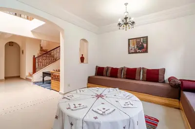 a living room with a table and a couch at Golden Palm 2 in Marrakech