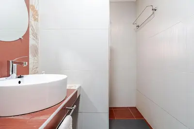 a white bathroom with a sink and a mirror at Golden Palm 2 in Marrakech