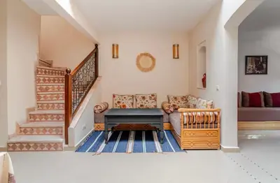 a living room with a couch and a staircase at Golden Palm 2 in Marrakech