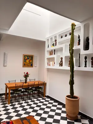a dining room with a table and a cactus at Dar Nook in Marrakech