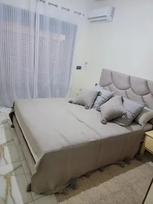 a large bed sitting in a room with a large window at Magnifique appartement sur Marrakech in Marrakech