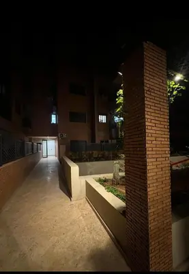 a room with a brick pillar in a building at night at Magnifique appartement sur Marrakech in Marrakech