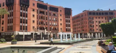 a group of buildings with a fountain in a courtyard at La Plaza cœur de Gueliz in Marrakech