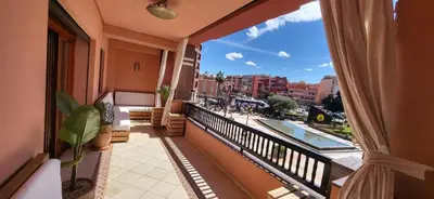 an apartment balcony with a view of a swimming pool at La Plaza cœur de Gueliz in Marrakech