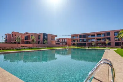 a swimming pool in front of a building at Le Noria - Super logement Jardin & Piscine - Golf in Marrakech