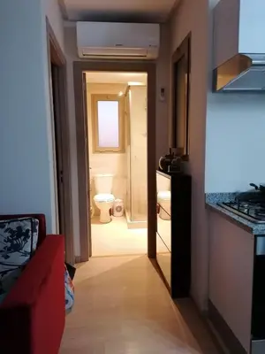 a hallway to a bathroom with a toilet and a sink at Prestigious residence marrakech with optical fiber in Marrakech