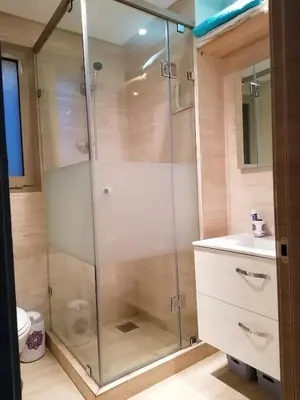 a shower with a glass door in a bathroom at Prestigious residence marrakech with optical fiber in Marrakech