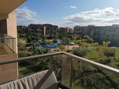 a balcony with a view of a resort at Prestigious residence marrakech with optical fiber in Marrakech