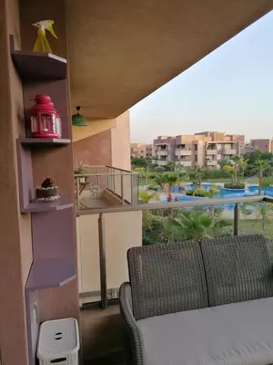 a balcony with a couch and a view of a city at Prestigious residence marrakech with optical fiber in Marrakech