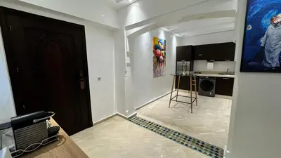 a living room with a door and a kitchen at Mms in Marrakech