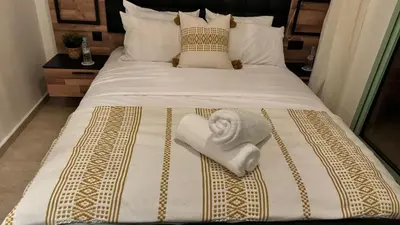 a bed with a white towel laying on it at Mms in Marrakech