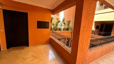 a hallway with a black door and a balcony at Mms in Marrakech
