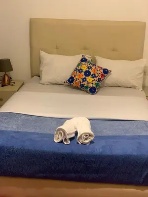 a bed with a pair of towels on it at Raid lkaram in Marrakech