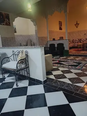a room with a bench with a hat on it at Raid lkaram in Marrakech