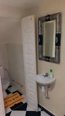 a bathroom with a sink and a mirror and a toilet at Raid lkaram in Marrakech