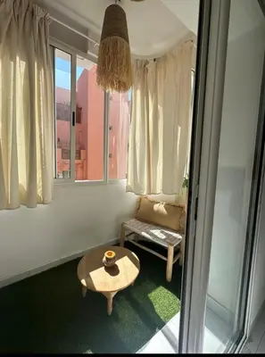a living room with a coffee table and a window at Confort et style en pleins centre ville in Marrakech