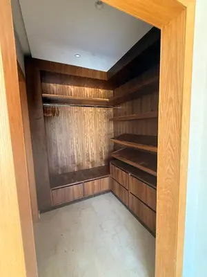 a walk in closet with wooden walls and shelves at Villa Famous 4 chambres in Marrakech