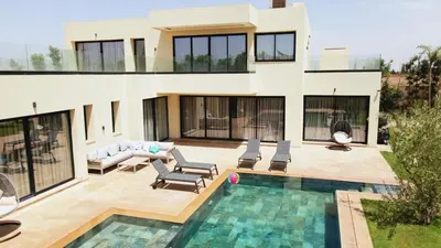 a house with a swimming pool in front of it at Villa Famous 4 chambres in Marrakech