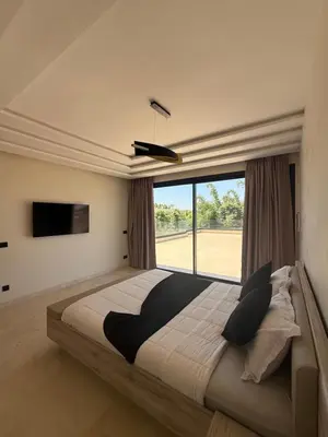 a bedroom with a large bed with a large window at Villa Famous 4 chambres in Marrakech