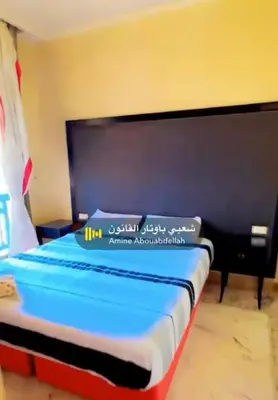 a bed in a room with a sign on it at Appartement La Palmeraie in Marrakech
