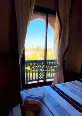 a room with a window with a bed and a view at Appartement La Palmeraie in Marrakech