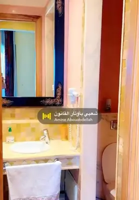 a bathroom with a sink and a mirror at Appartement La Palmeraie in Marrakech