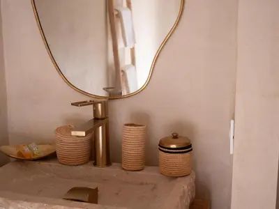 a bathroom sink with a mirror on top of it at Riad Dar Sary Marrakech médina privé 3 chambres in Marrakech