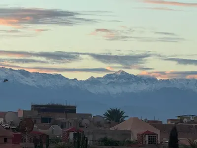 a view of a city with mountains in the background at Riad Dar Sary Marrakech médina privé 3 chambres in Marrakech