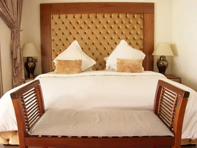 a bedroom with a large bed with white sheets and pillows at Timeless Villa at Golf course with private pool in Marrakech