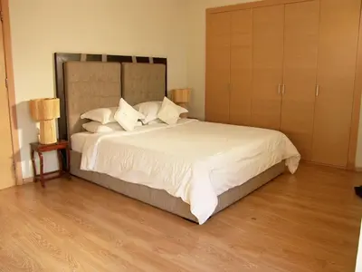 a bedroom with a large bed with white sheets and pillows at Timeless Villa at Golf course with private pool in Marrakech